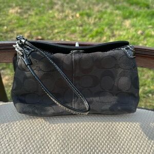 Black Coach wristlet with turnlock closure